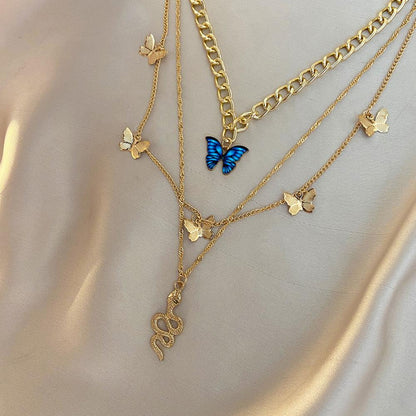RAIRA Golden Butterfly & Snake Layered Necklace Set – Elegant Charm with a Bold Edge
