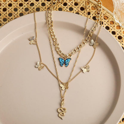 RAIRA Golden Butterfly & Snake Layered Necklace Set – Elegant Charm with a Bold Edge