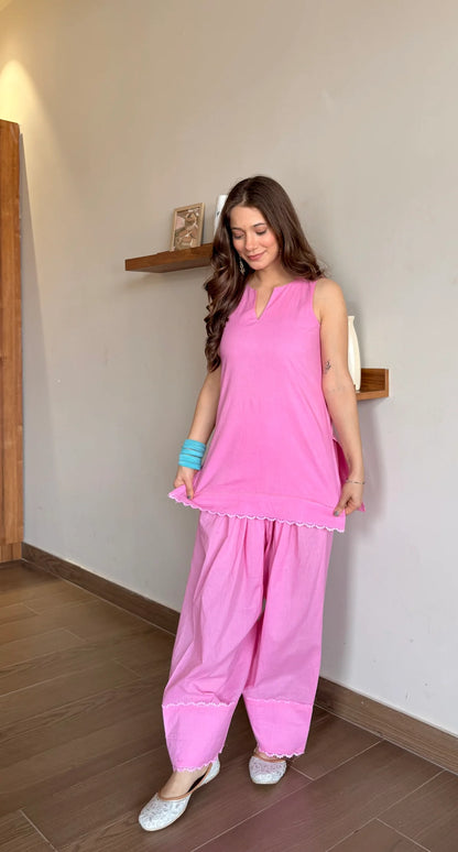 Woman wearing a pink traditional Farshi Suit Salwar outfit 