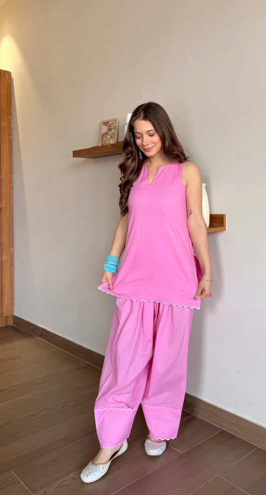 Woman wearing a pink traditional Farshi Suit Salwar outfit 
