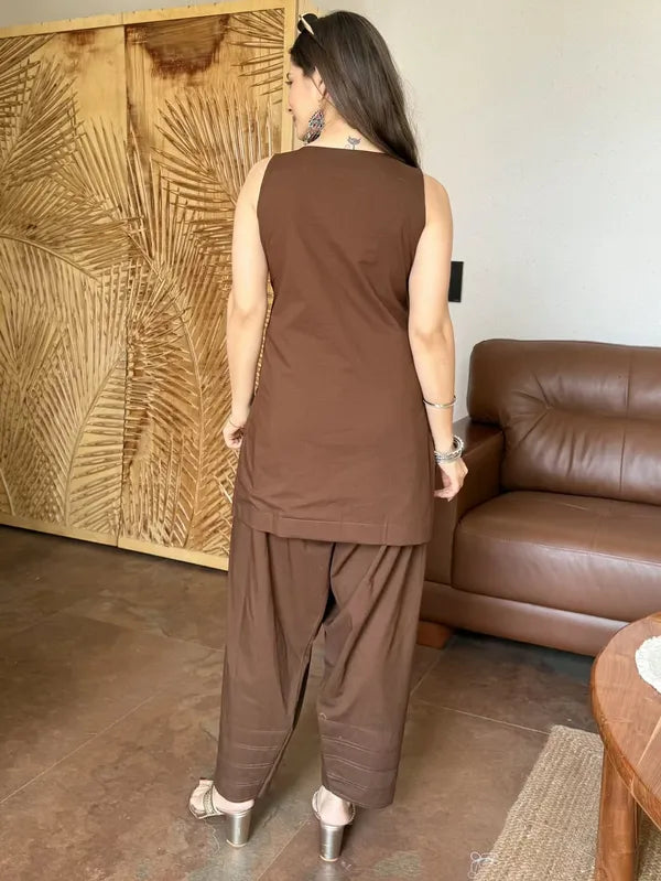 A woman shown from behind wearing a brown sleeveless Farshi Suit Salwar , cotton Fabric
