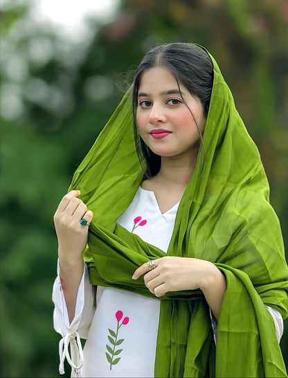 A woman wearing a Farshi  kurta with pink floral embroidery and a bright green dupatta, 